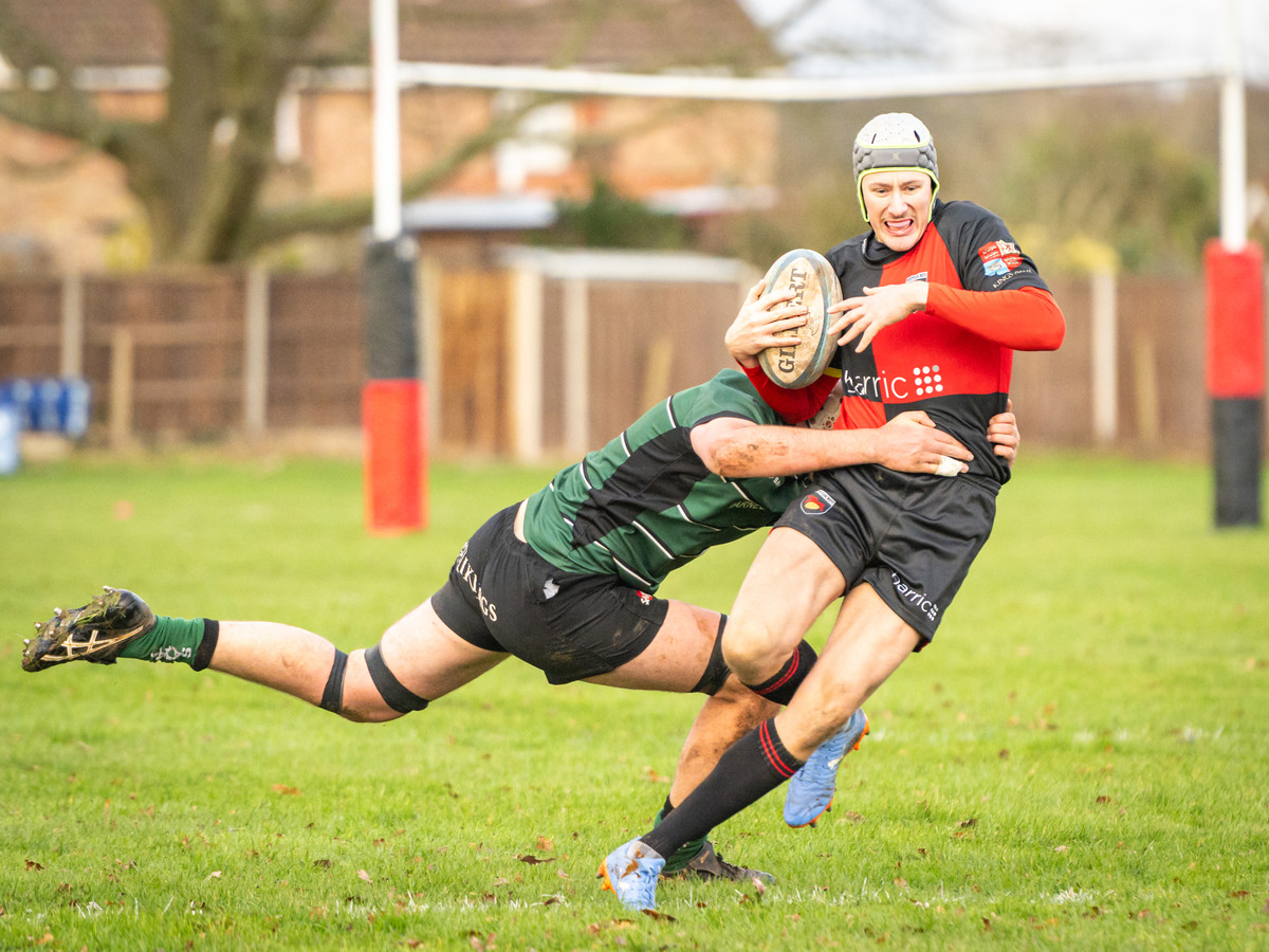Male Rugby players with a tackle in progress